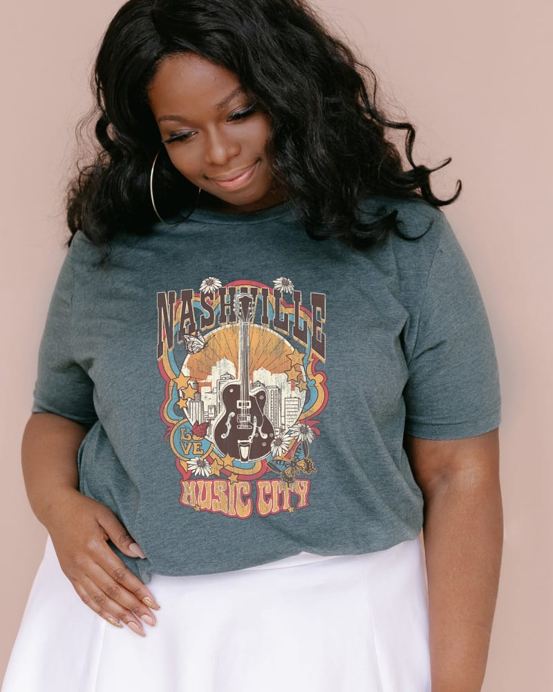 Front of a model wearing a size XL Music City Flowers in Forest by Simply Sage Market. | dia_product_style_image_id:281524